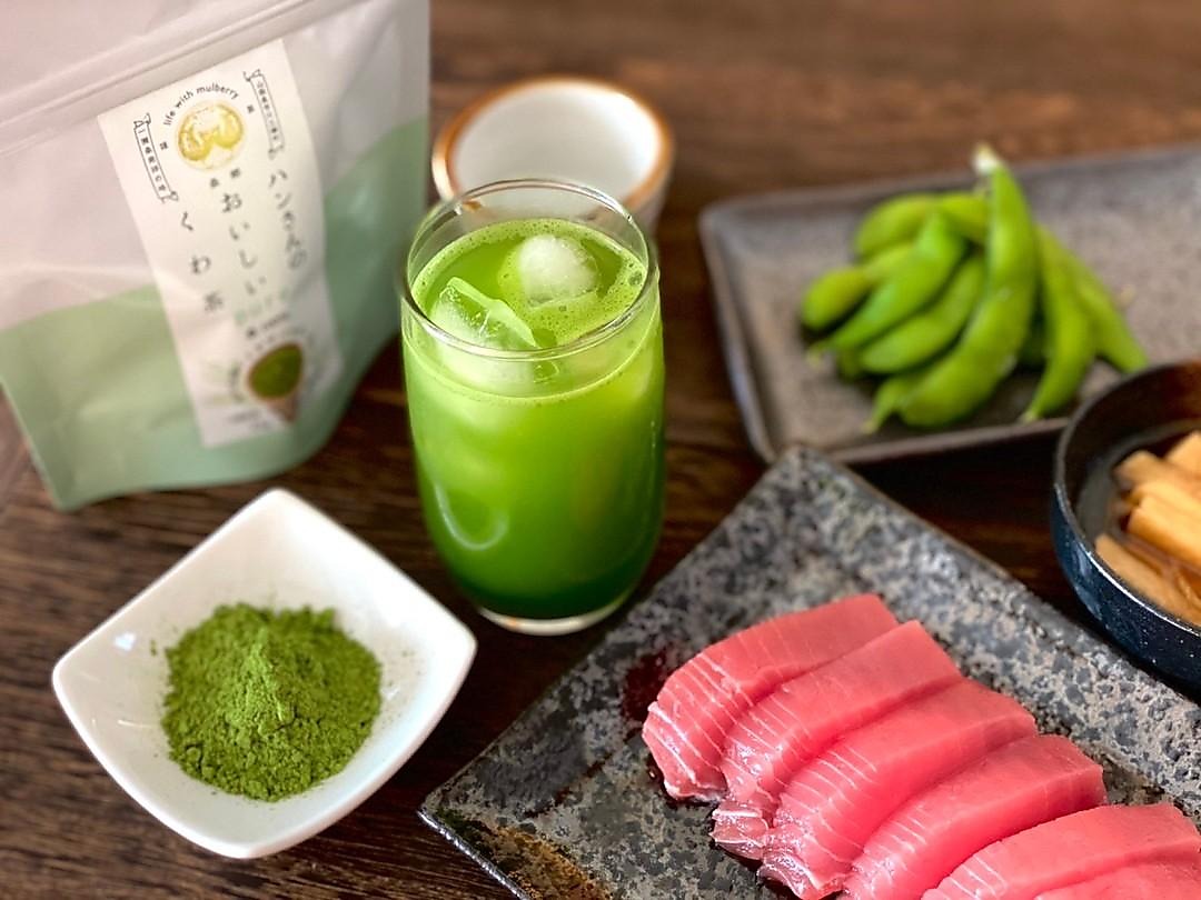 Kuwa Matcha product pouch, green iced drink, powder, and Japanese food — a full culinary lifestyle spread